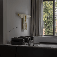 Living room with sheer curtains and black accent stools